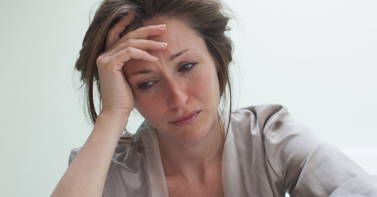 Person with hand on their head looking worried.