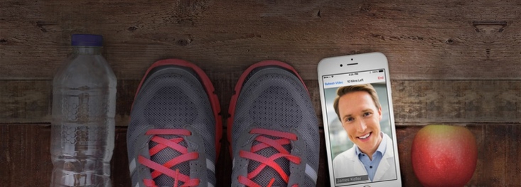 Running shoes and phone with telehealth visit open